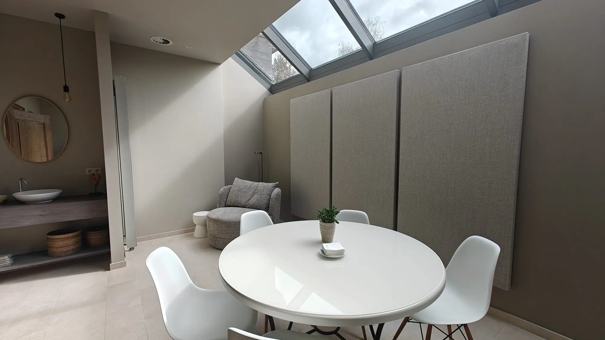Dining area with tall acoustic wall panels in a bright room