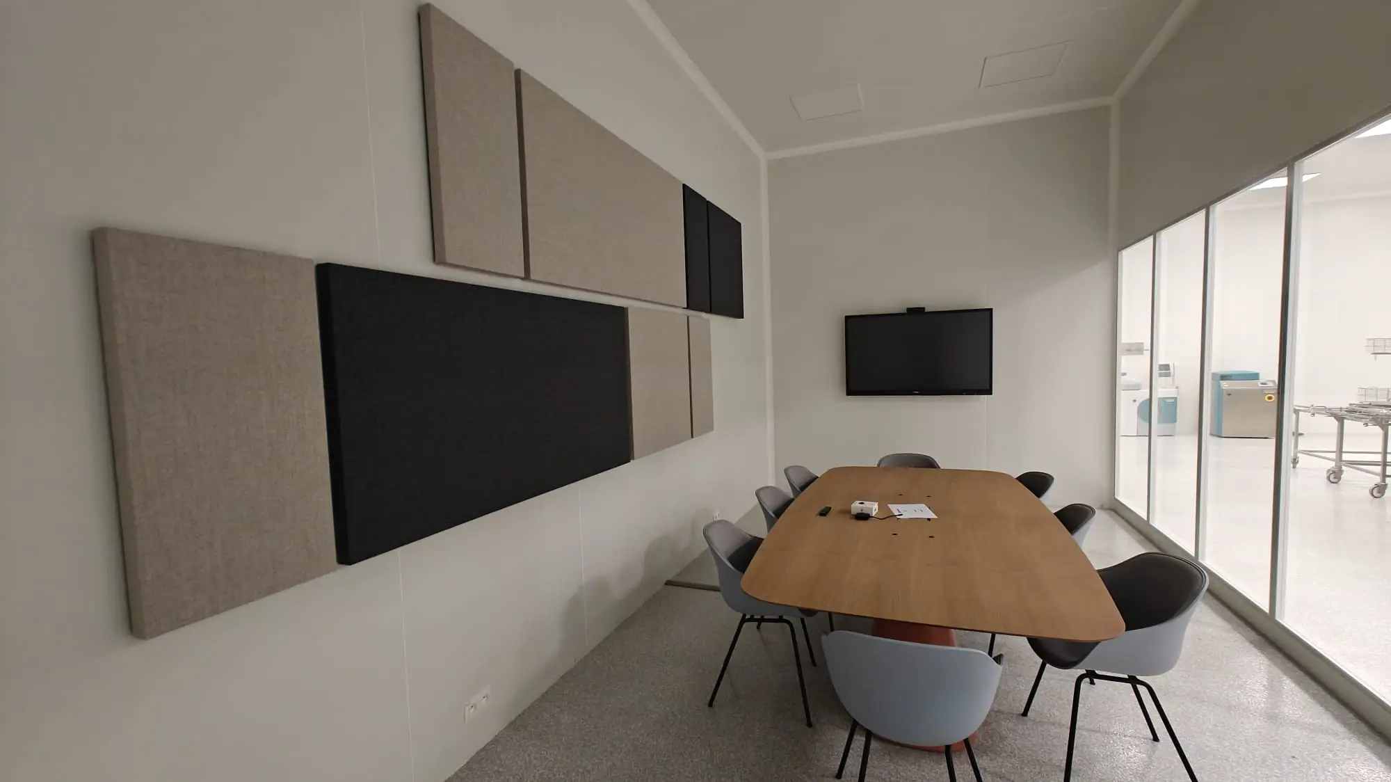 Meeting room with acoustic wall panels in black and beige